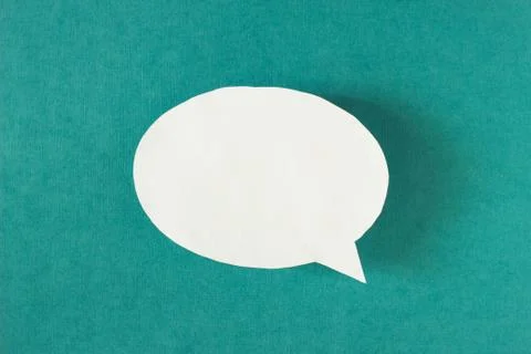White bubble message from a paper on a turquoise background, social network Photos