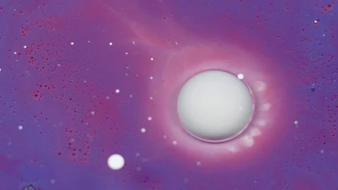 White bubble of paint burst on the purple oil surface. Paint in oil. Video stock 105190357