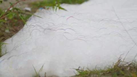 White bubble soap foam on the lawn Stock Footage 252636886