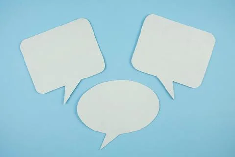 White bubble speech top view on blue background Stock Photos