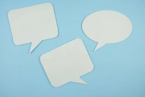 White bubble speech top view on blue background Stock Photos
