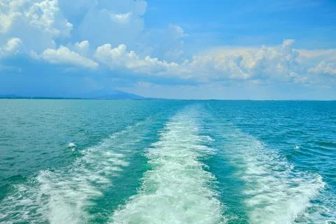 White bubbles and splashes of waves on the stern of the ferry ship. Stock Photos
