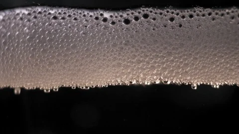 White bubbles floating on a beer liquid. slow motion Stock Footage 89305500