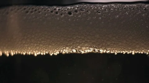 White bubbles floating on a  cider liquid. Stock Footage 89307592