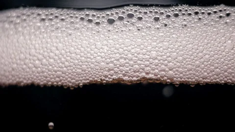 White bubbles floating on a liquid. light change Stock Footage 89307038