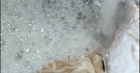 White Bubbles Over Brown Linens Stock Footage 83079149