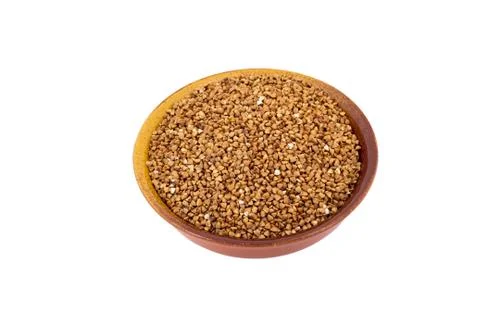 White Buckwheat on brown, ceramic, deep, plate isolated on white background Stock Photos