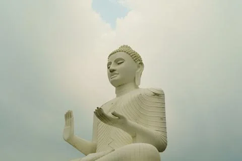 White buddha on cloudy sky background Stock Photos