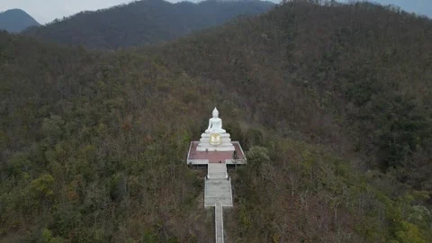 White Buddha Statue Amidst Mountain Landscape in Pai, Mae Hong Son, Thailand Stock Footage 335571161