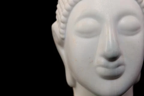 White buddha statue on black background closeup of head Stock Photos