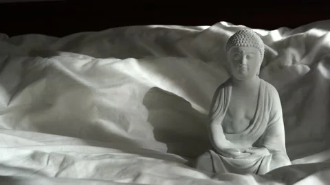 White buddha statue with sunlights on the bed, interior design detail Stock Footage 233342725