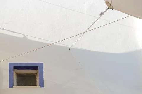 A white building with blue window frames in the Greek style. Travel and Stock Photos
