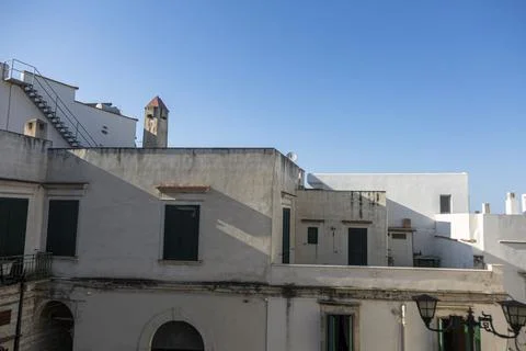 A white building with a clock tower in the background Stock Photos