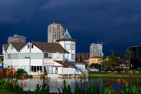 White building foreground reflected with approaching thunderstorm background in Stock Photos
