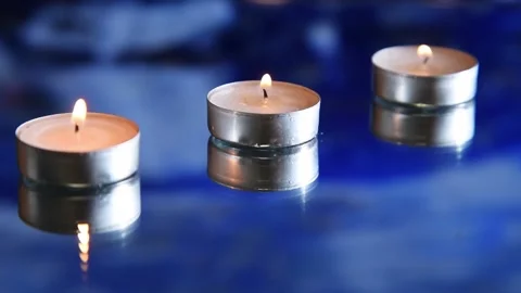 White burning candles in water Stock Footage 167601624