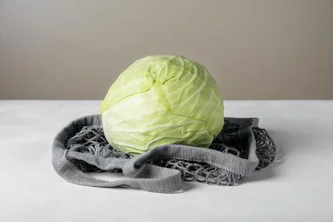 White cabbage lie on the surface in environmentally friendly bag Stock Photos