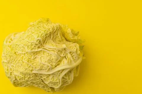 White cabbage lies on a yellow background Stock Photos