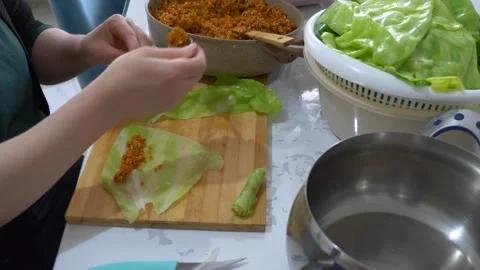 White cabbage to make stuffed vegetables, a woman making stuffed vegetables.. Video stock 256583617