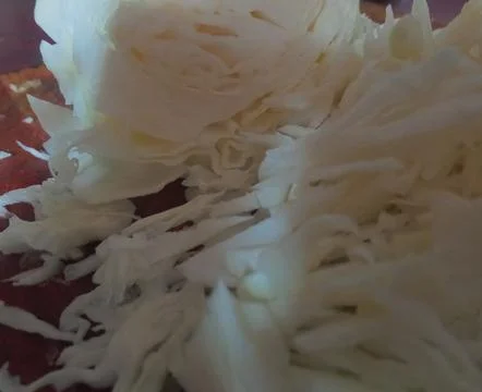 White cabbage sliced ​​thinly in the kitchen Stock Photos