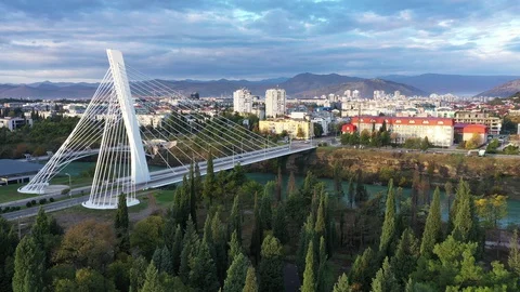 White cable bridge on Moraca river in Podgorica Montenegro in the morning Stock Footage 127798692