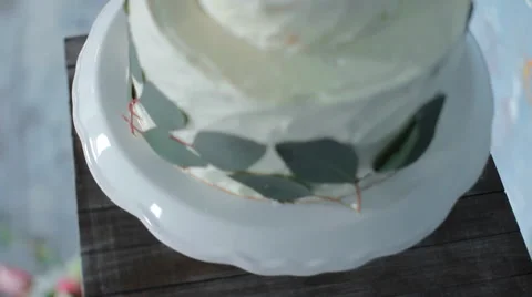 White Cake Fine Art on the Table. Fresh Leaves. Stock Footage 65663828