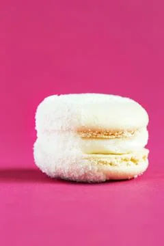 White Cake macaron or macaroon on pink background. Stock Photos