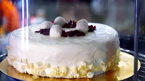 White cake on a rotating showcase Stock Footage 246438134
