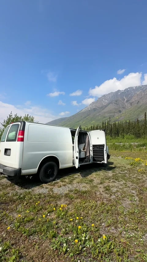 White camper van parked by mountains enjoying nature Stock Footage 341853522