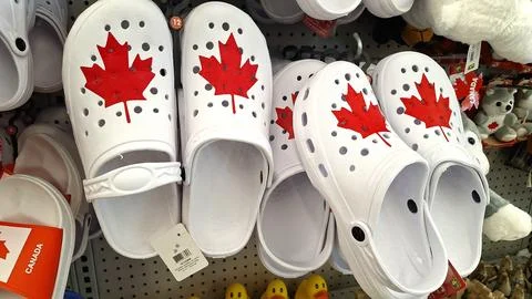 White Canadian maple leaf clogs displayed on store shelf Stock Photos