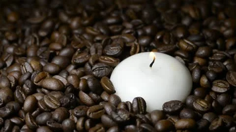 White candle and falling coffee beans Stock Footage 22105490