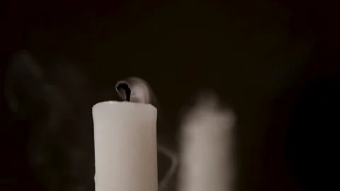A white candle on a black mirror background. A candle is blown out, beautiful Stock Footage 205596210