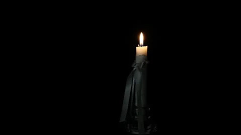 A white candle burning in the dark-1 Stock Footage 306767283