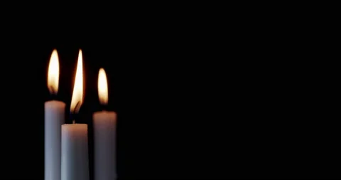 A white candle burning. Isolated candle burning with dark background.White Stock Footage 170425370