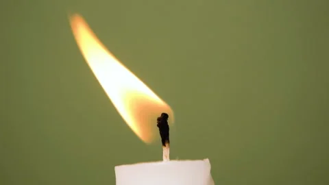 A white candle burning on a olive background. A candle is blown out, beautiful Stock Footage 209158645