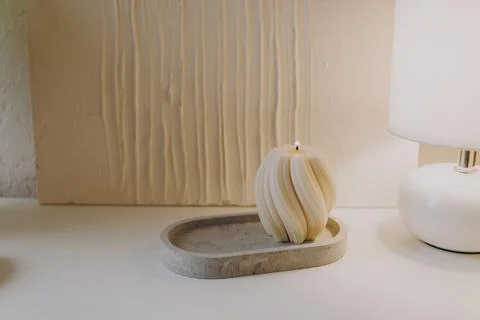 A white candle burns on the table Stock Photos