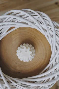 White candle in the centre of the wicker frame Stock Photos