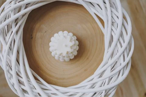 White candle in the centre of the wicker frame Stock Photos