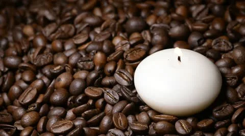 White candle on coffee beans Stock Footage 22105530
