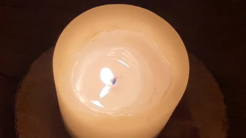 White candle on a dark brown table Stock-Footage 119207750