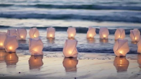 White candles on the beach create a serene summer scene with sand, sea, and sky Video stock 310644410