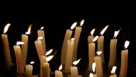 White candles burn on a black background. C0180 Video stock 255166259