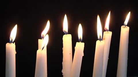 White candles burning on black background Stock Footage 8960566