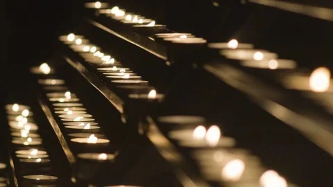 White Candles Burning Peacefully. One Candle In Focus, Other Candles Out Of Stock Footage 74002943