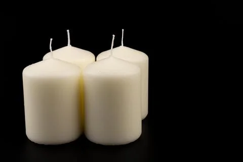 White candles on dark background. Close-up, copy space. Stock Photos