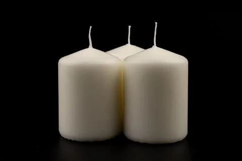 White candles on dark background. Close-up, copy space. Stock Photos