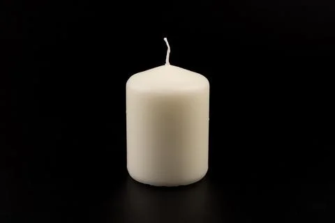 White candles on dark background. Close-up, copy space. Stock Photos