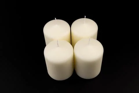 White candles on dark background. Close-up, copy space. Stock Photos