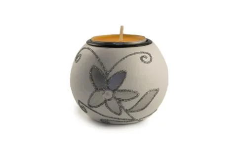 White candlestick with ball-shaped lighting candle on a white background Stock Photos