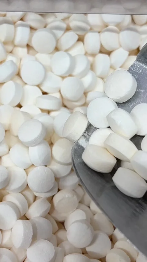 White candy scoop Detailed view of white chocolate chips being scooped with a Stock Footage 316088494