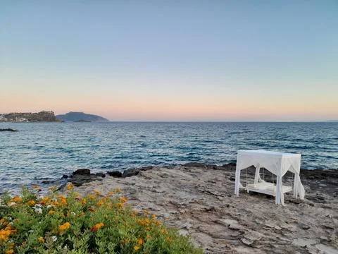 White canopy covered daybed overlooking blue sea in Greece Stock Photos